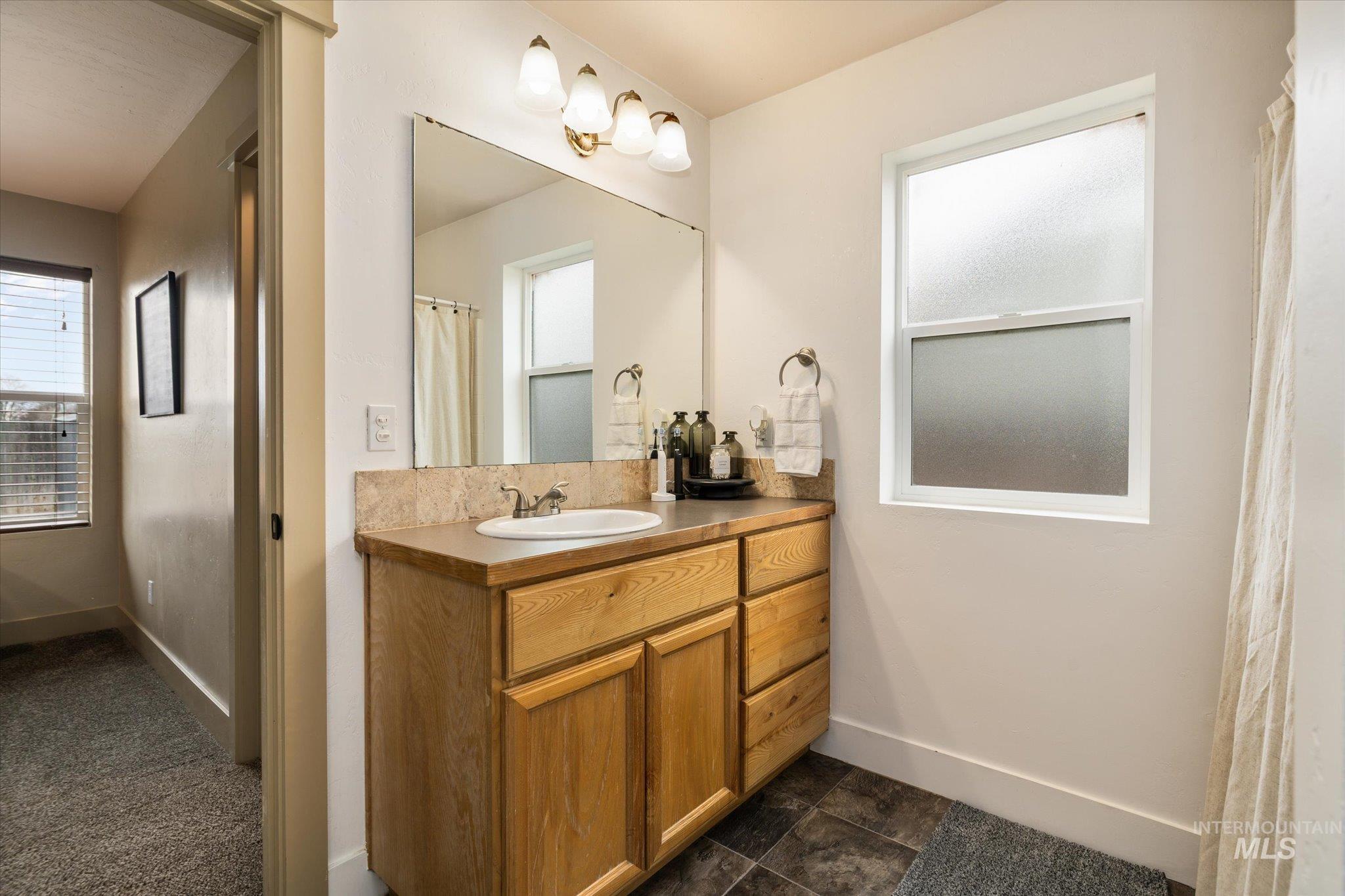 Bathroom featuring vanity, a shower with curtain, and plenty of natural light