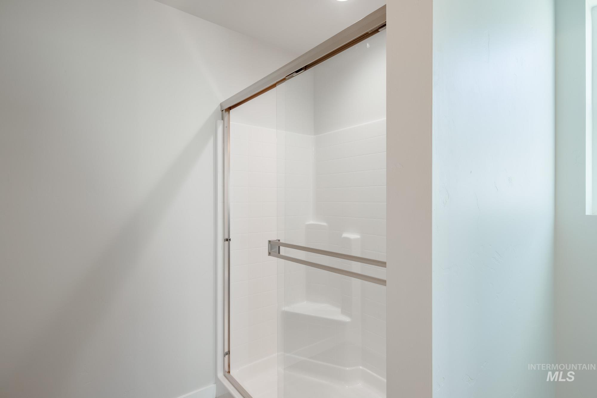 Full bathroom featuring a shower stall