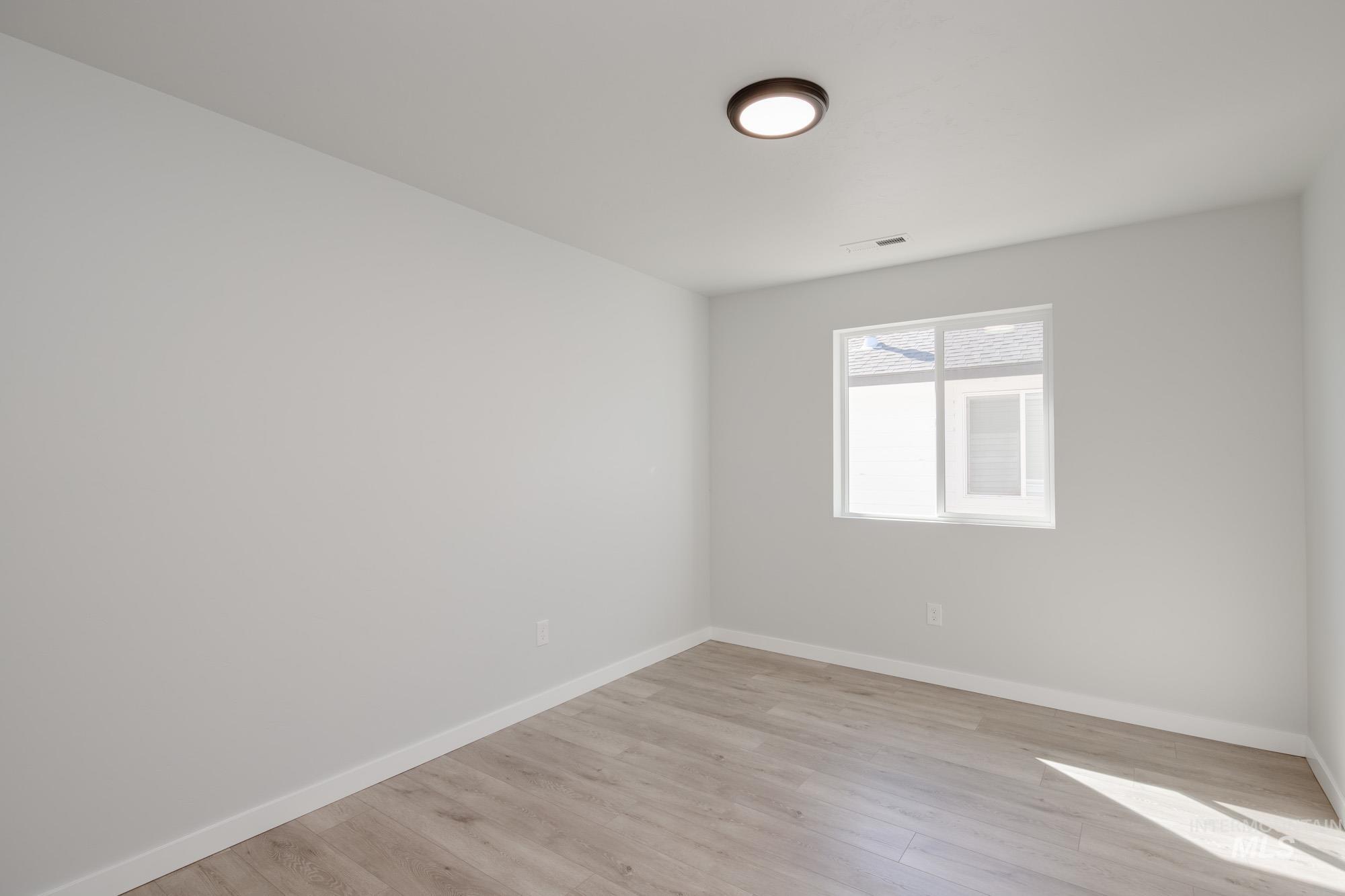 Empty room with light wood-style floors