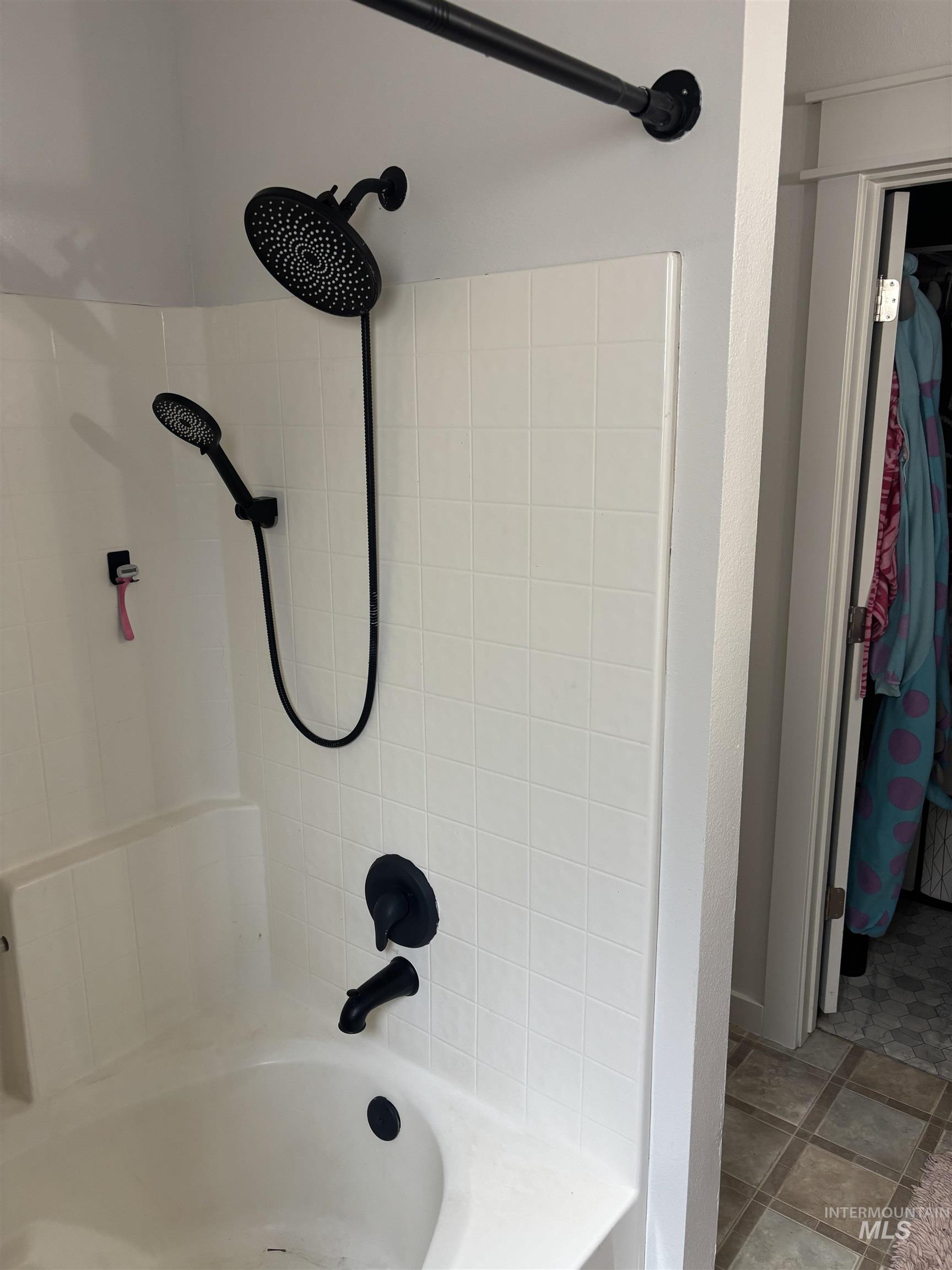 Full bath with shower / tub combination and a walk in closet