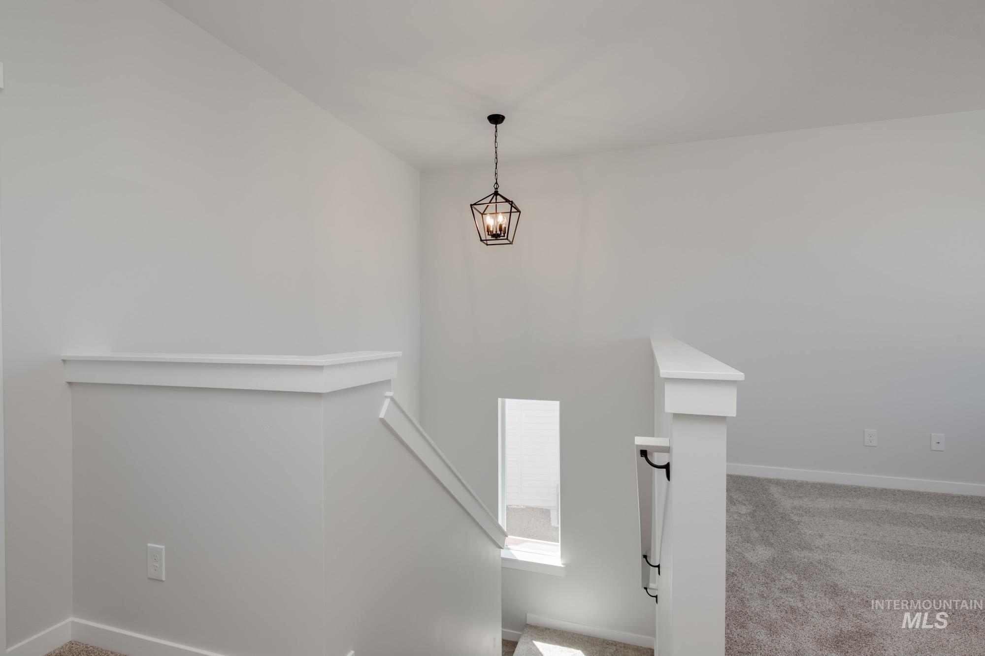 Stairs with carpet flooring and baseboards