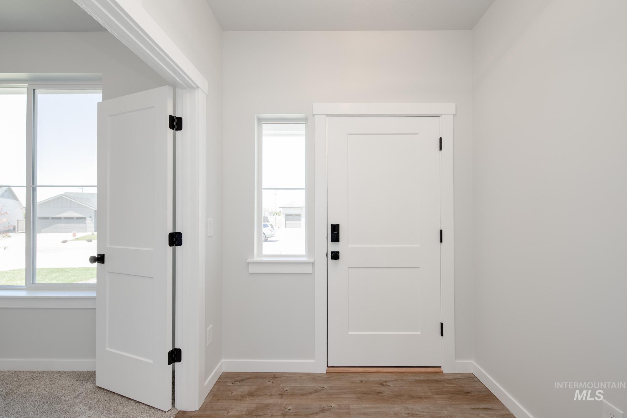 Foyer entrance with baseboards and light wood finished floors