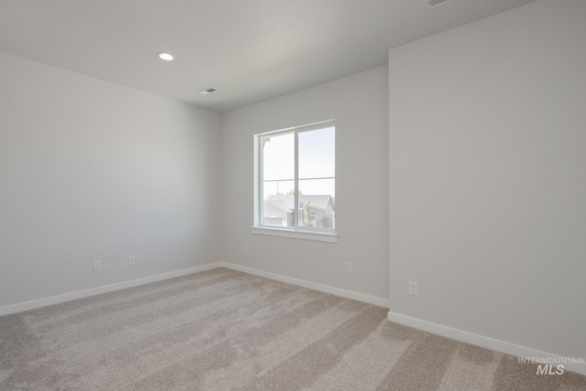 Unfurnished room with light carpet and recessed lighting