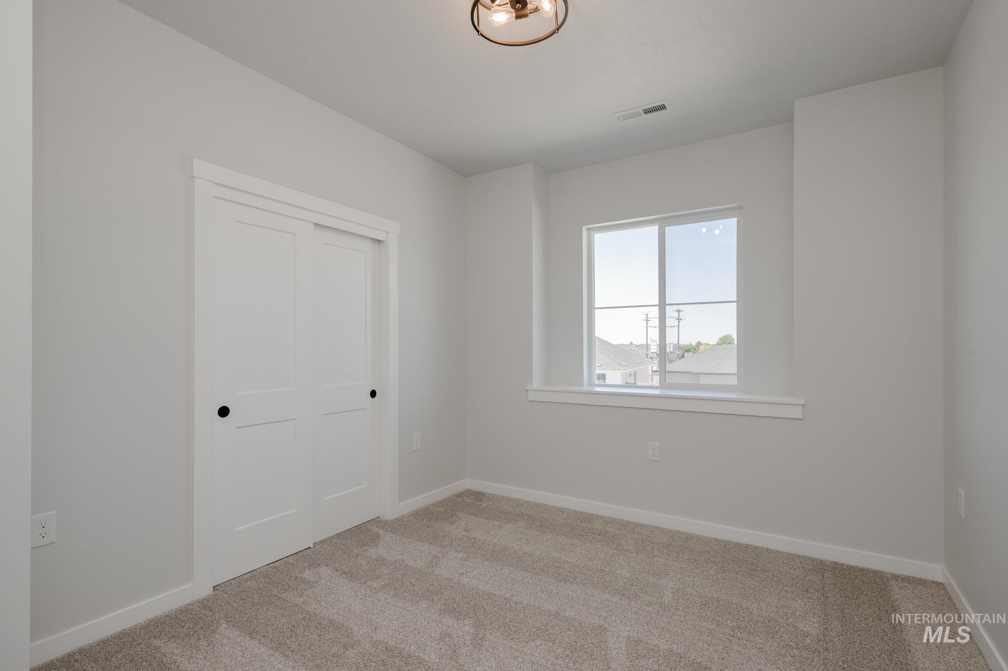 Unfurnished bedroom with carpet flooring and a closet