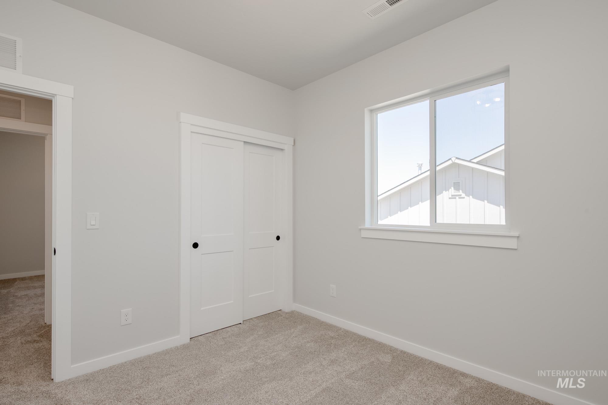 Unfurnished bedroom featuring carpet floors and a closet