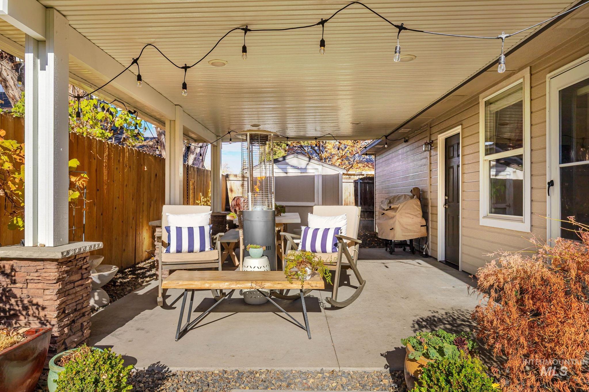 View of patio with a storage shed