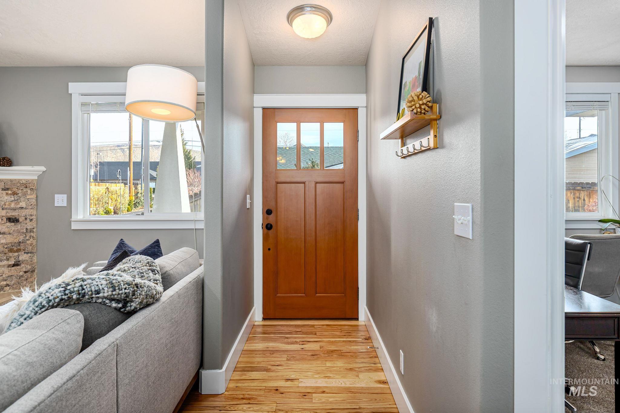 Entryway with plenty of natural light and wood finished floors