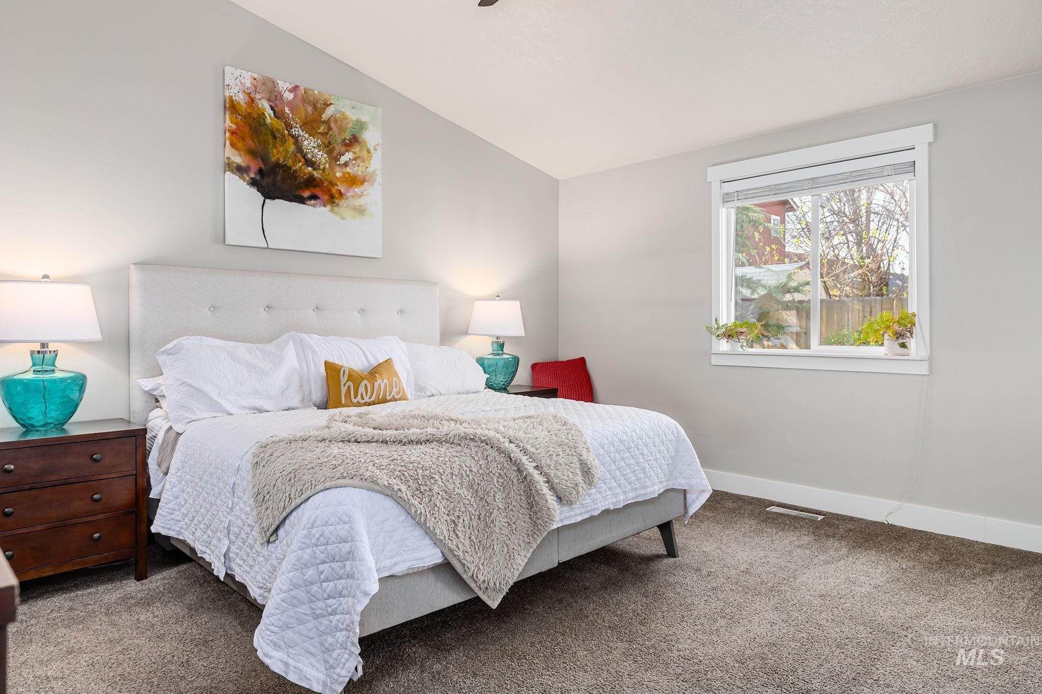 Bedroom featuring vaulted ceiling and carpet floors