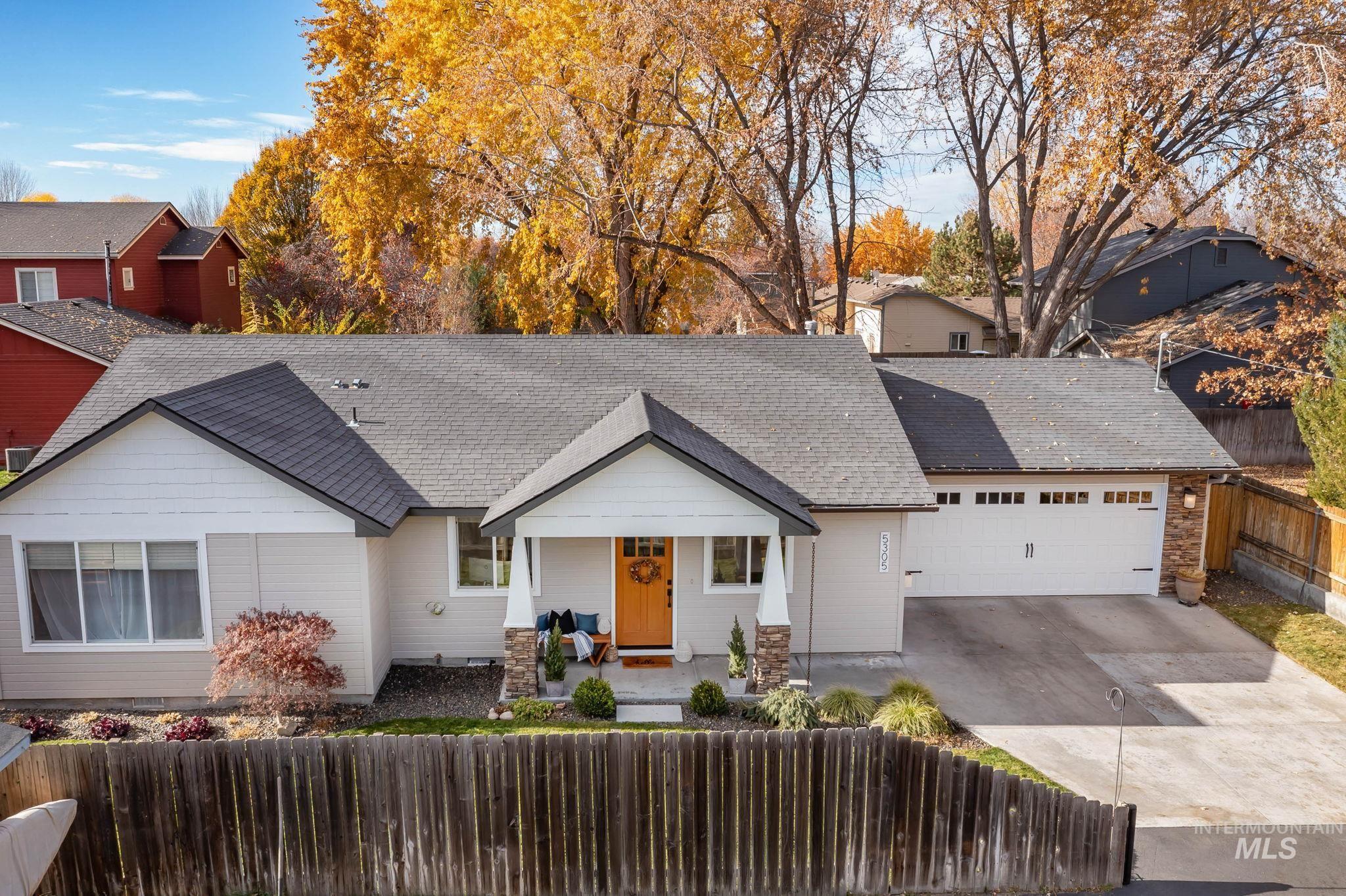 View of front of home featuring covered porch, driveway, a shingled roof, and an attached garage