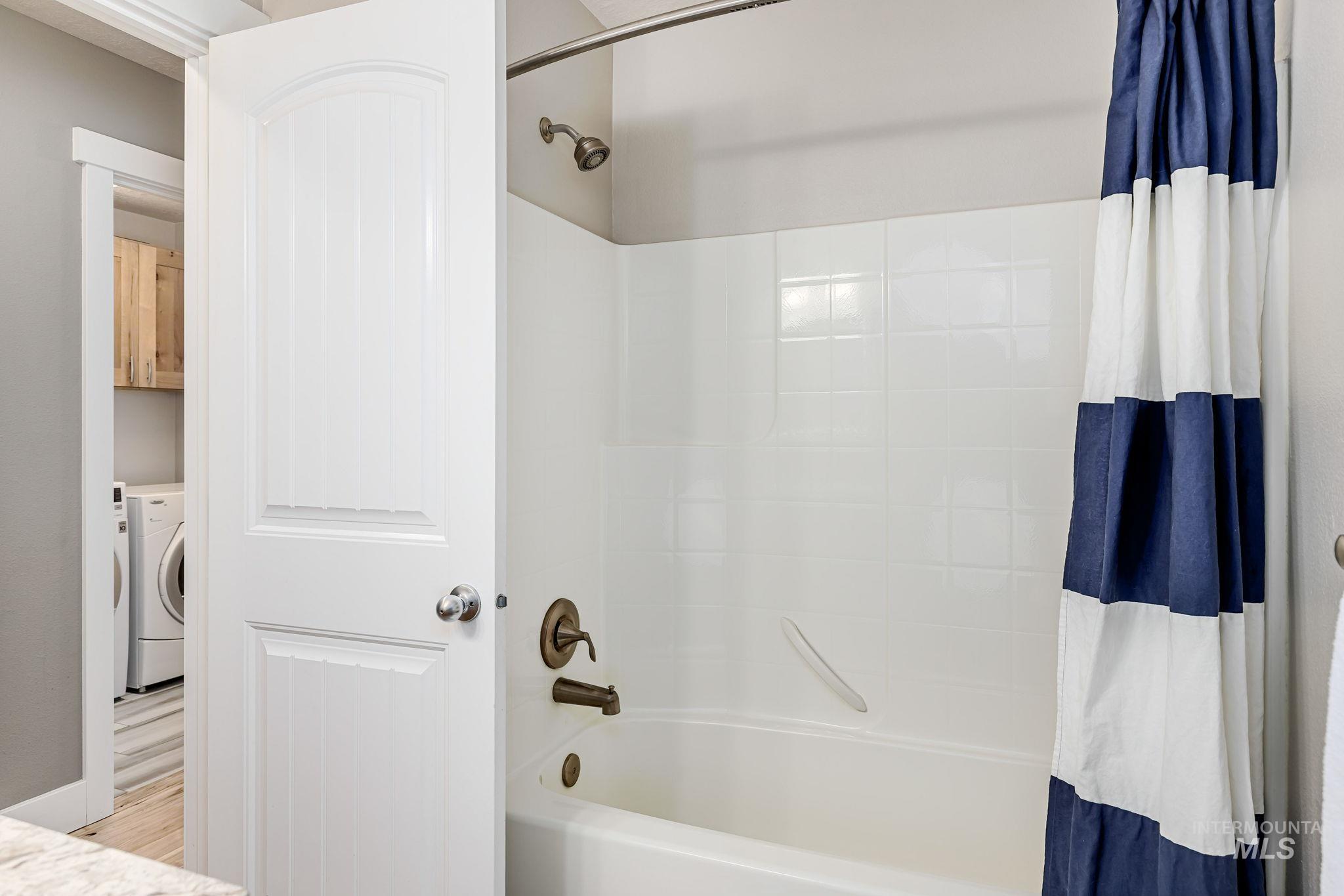 Bathroom with shower / tub combo and vanity