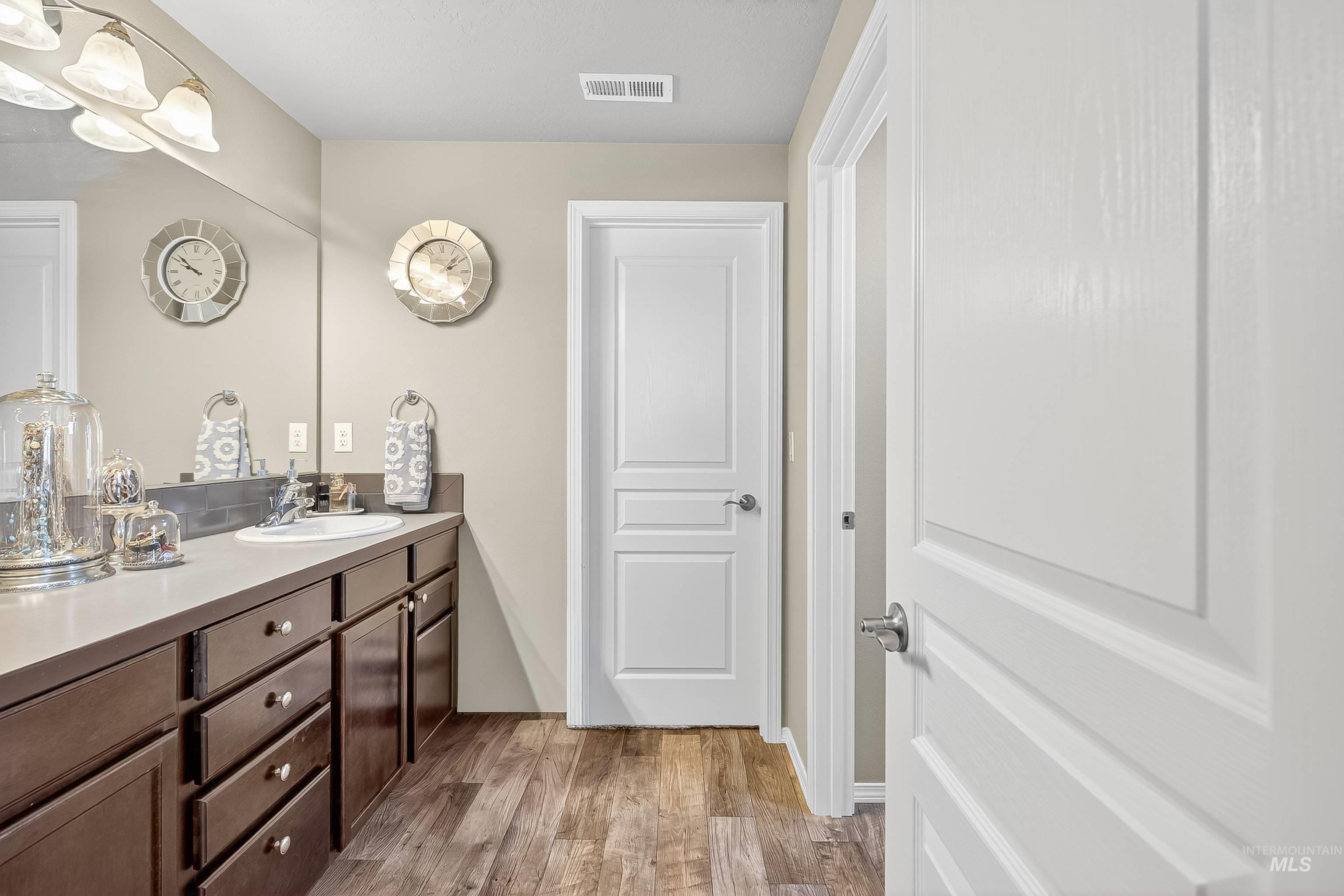 Bathroom with light wood-type flooring and vanity