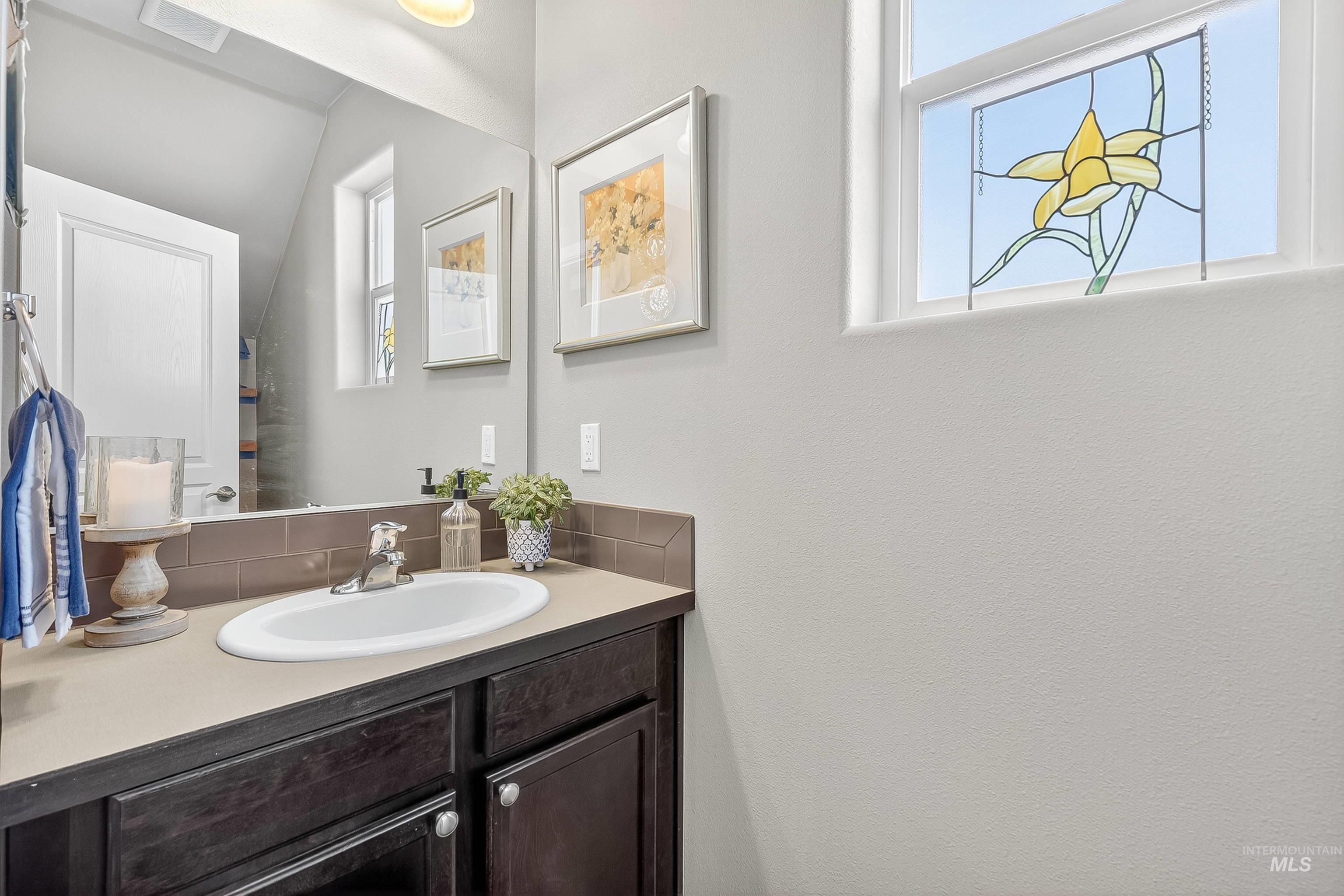 Bathroom featuring healthy amount of natural light and vanity
