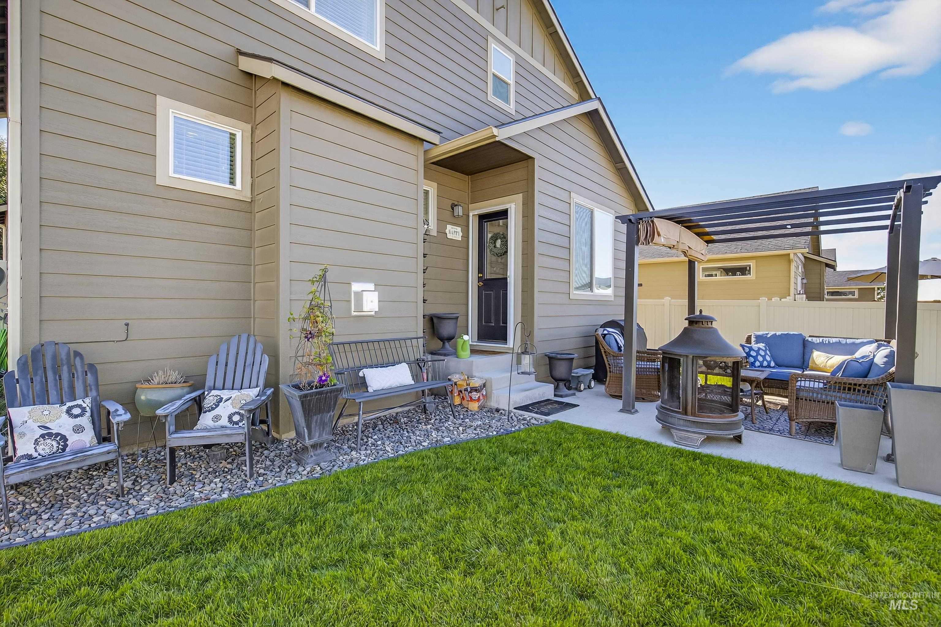 Rear view of property with outdoor lounge area, a patio area, and board and batten siding