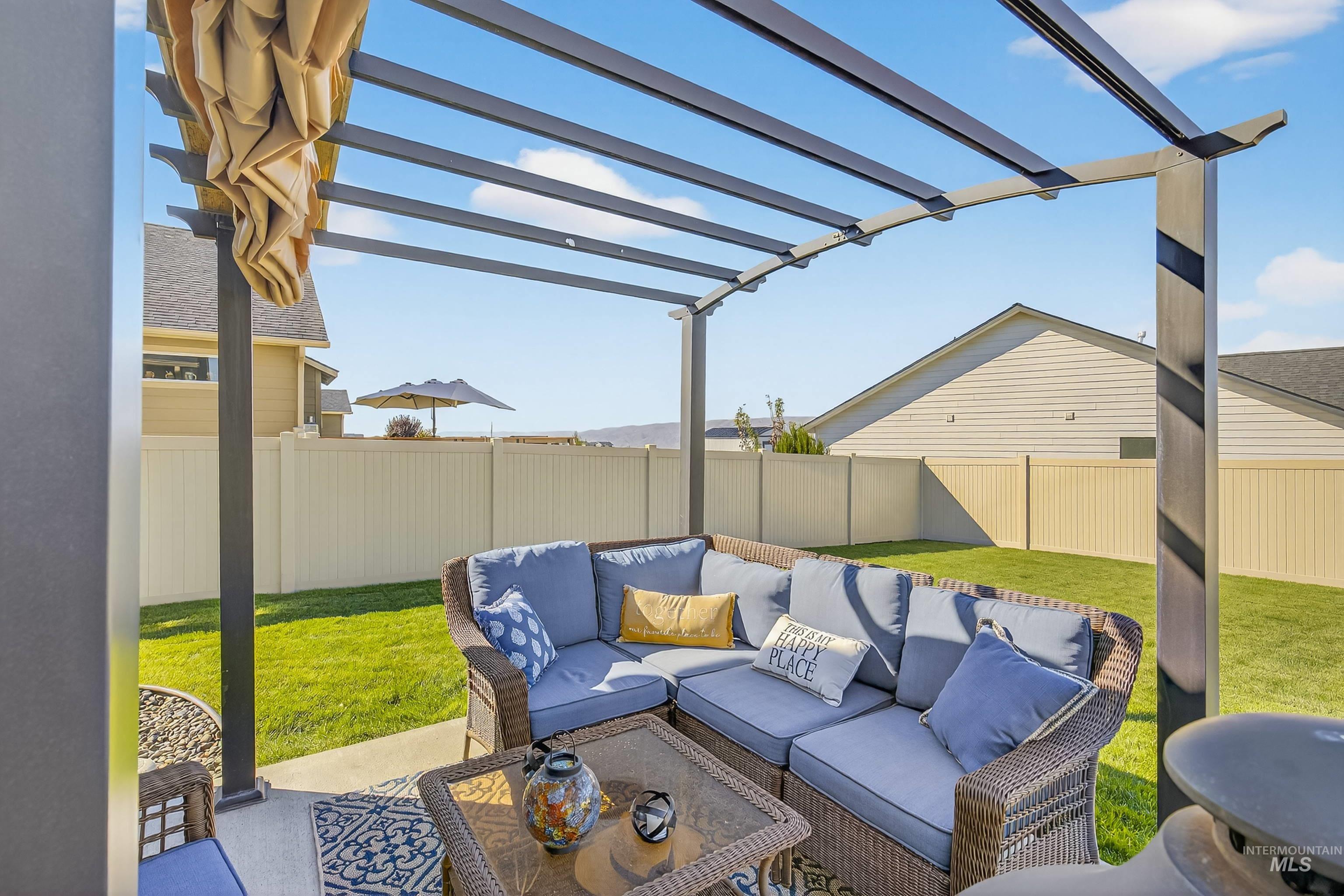 Fenced backyard featuring outdoor lounge area, a patio, and a pergola