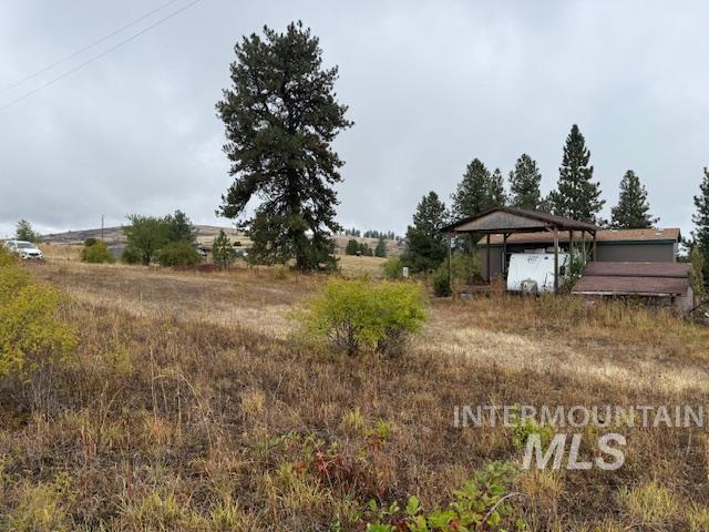 View of yard with a rural view