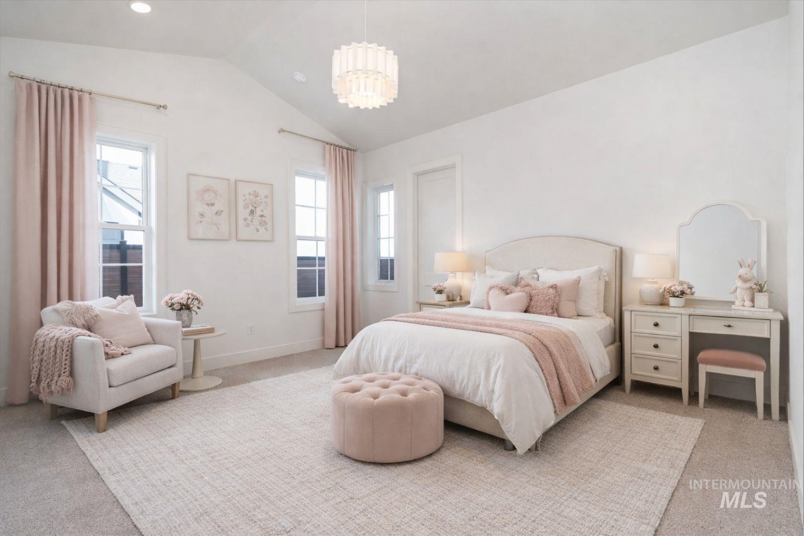 Spacious bedroom with vaulted ceilings, featuring four paneled windows, a modern chandelier, and plush carpeting