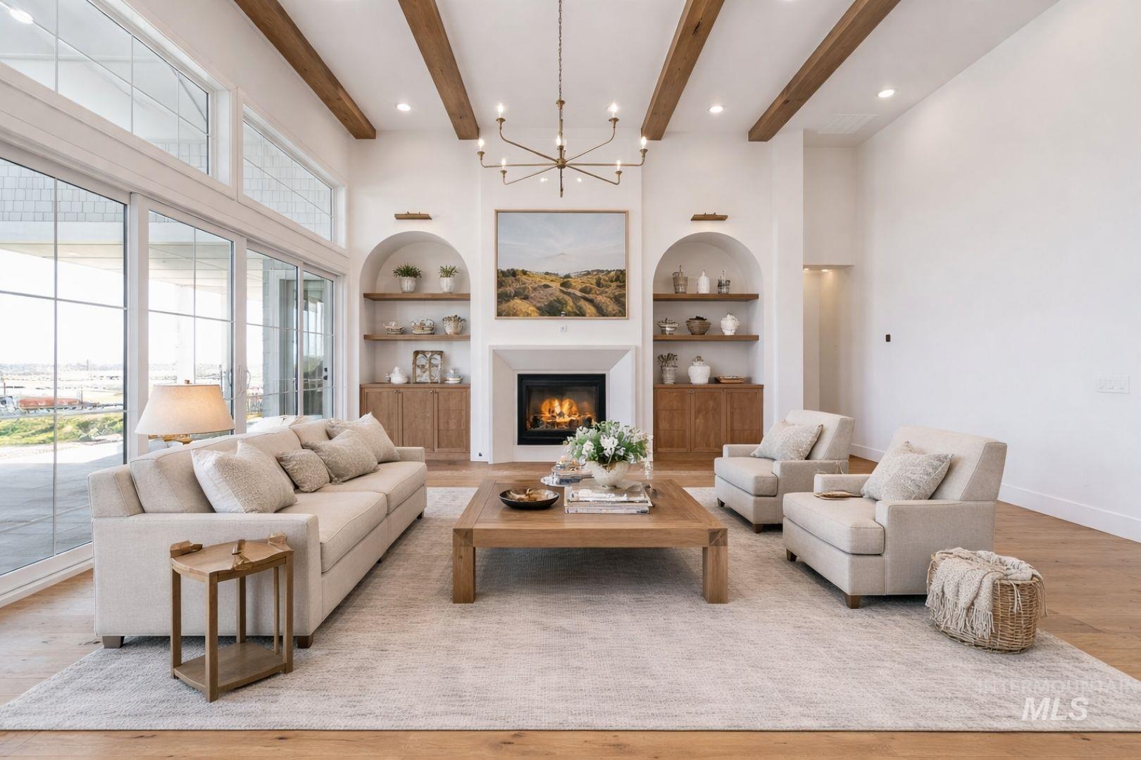 Spacious living area featuring exposed ceiling beams and recessed lighting