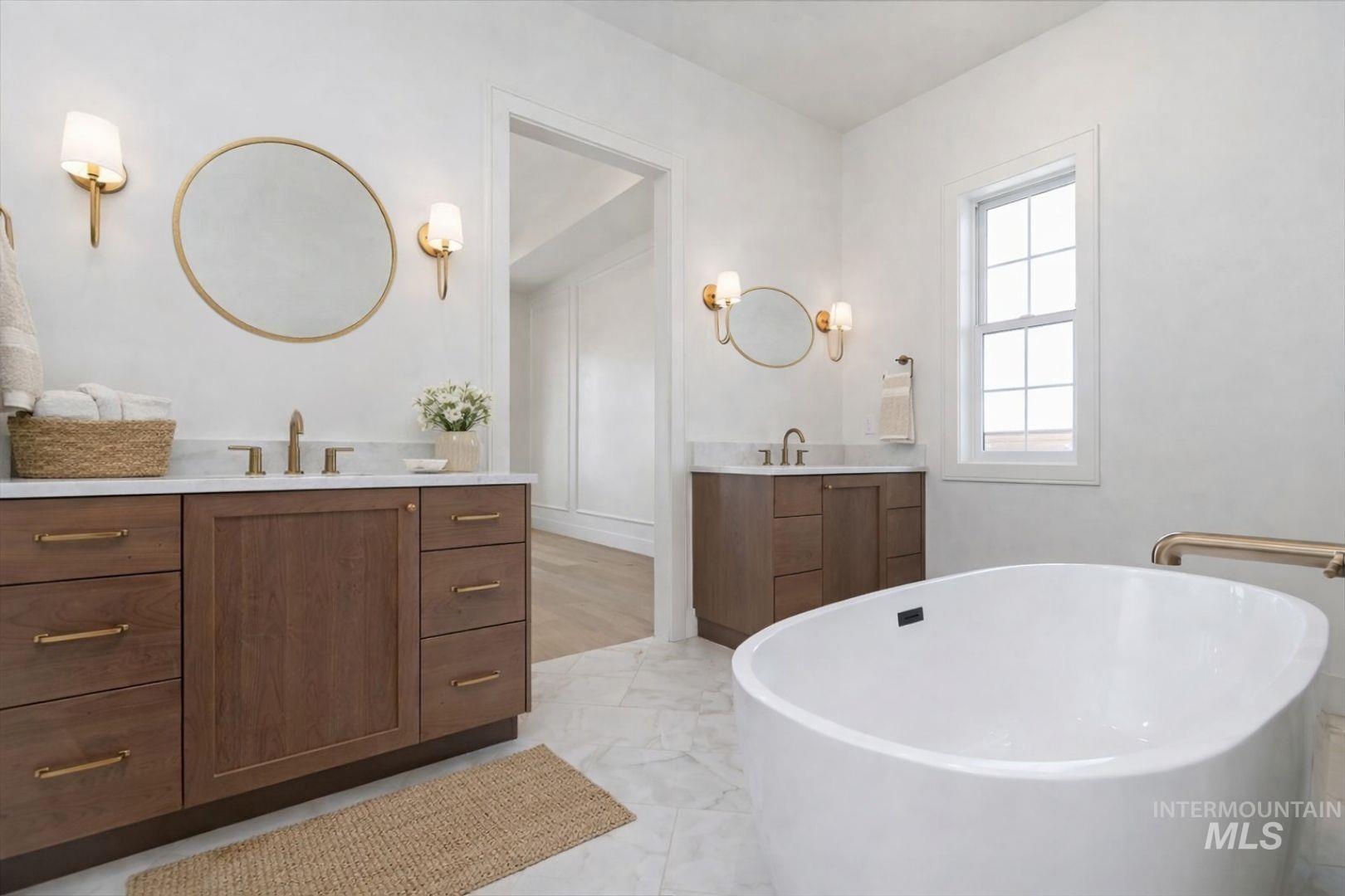 Freestanding soaking tub with gold-tone fixtures