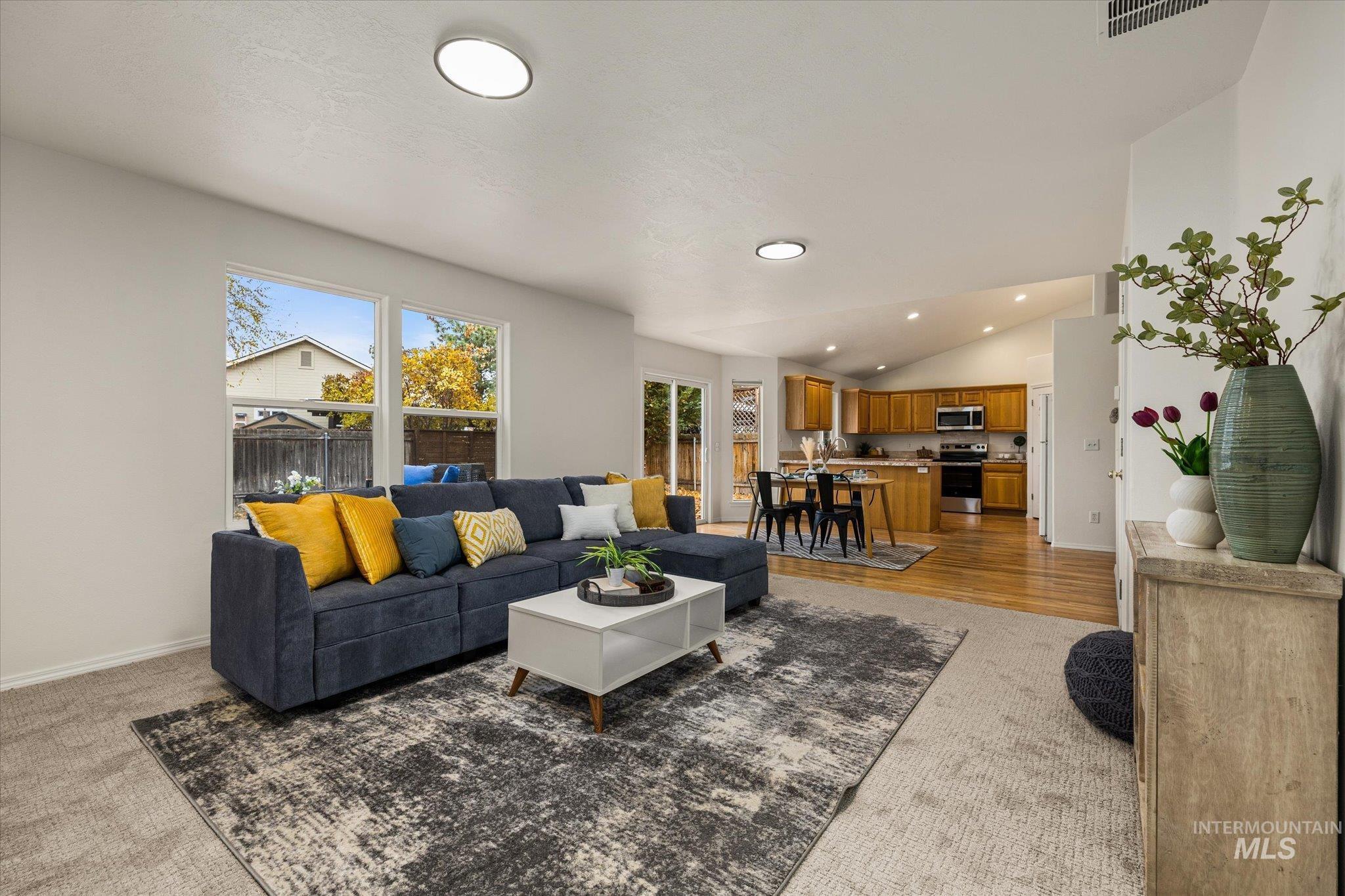 Living room featuring vaulted ceiling and recessed lighting
