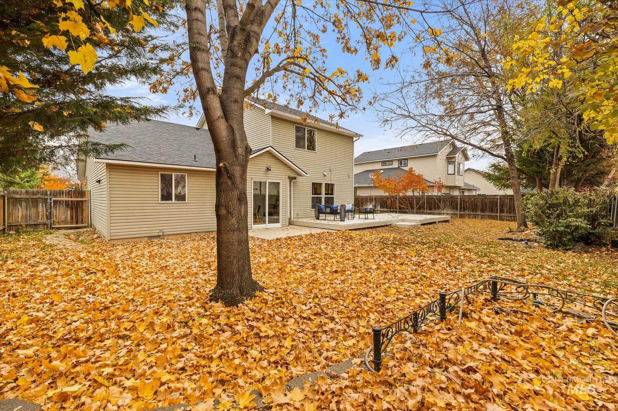 Back of property featuring a patio, a fenced backyard, and a shingled roof