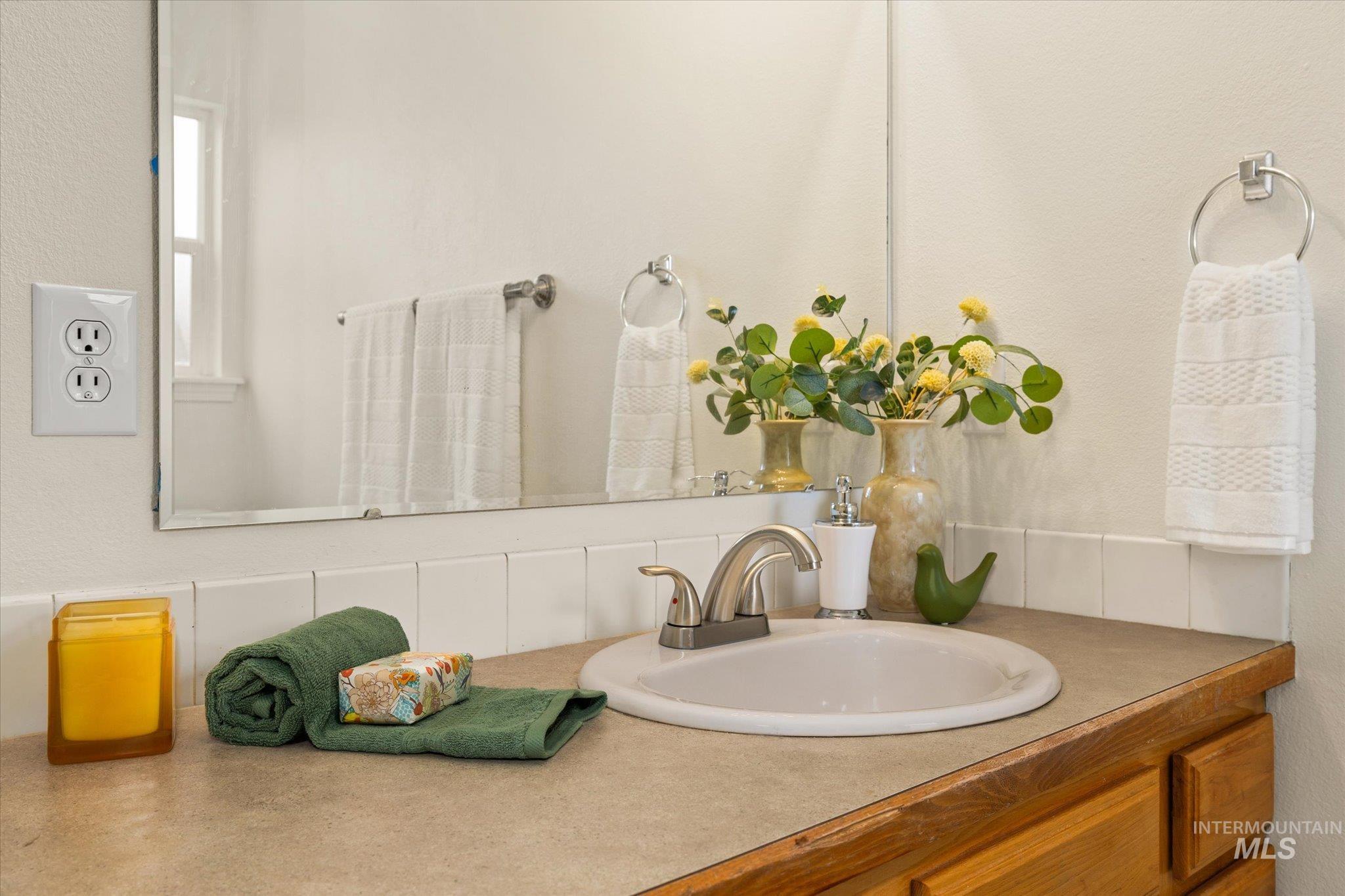Bathroom featuring vanity and a textured wall
