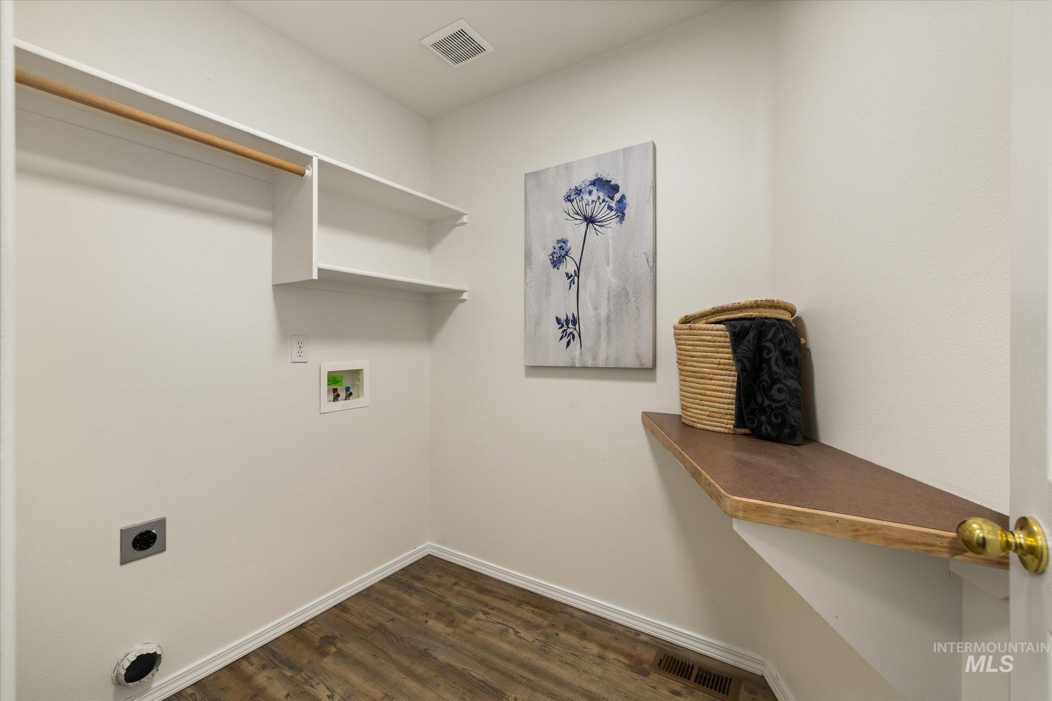 Laundry area with dark wood-style floors, electric dryer hookup, and washer hookup