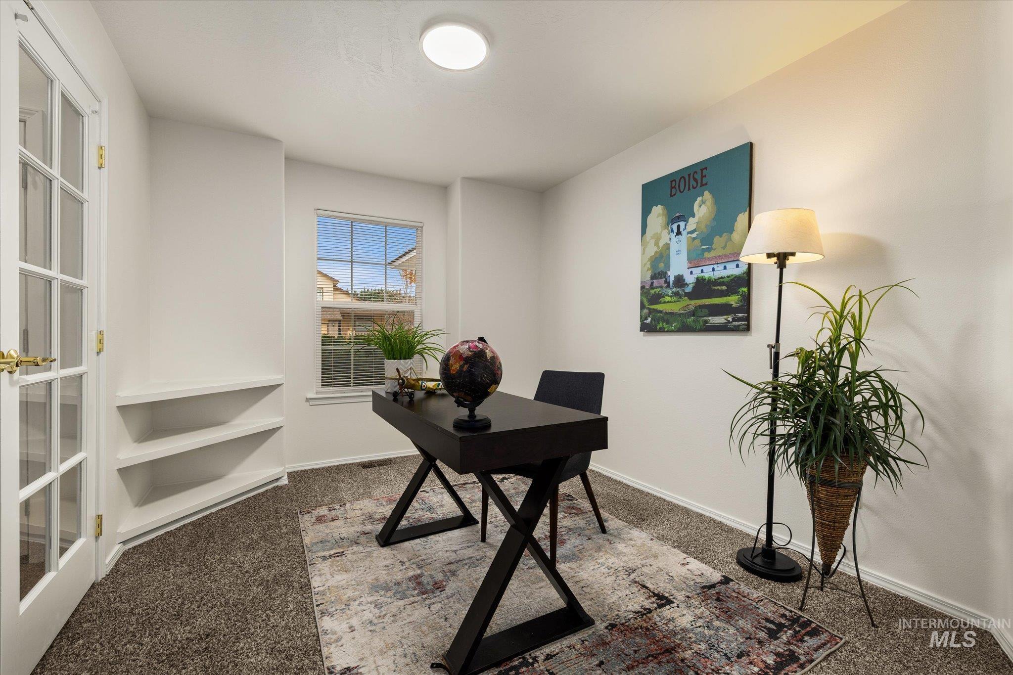 Carpeted home office with baseboards