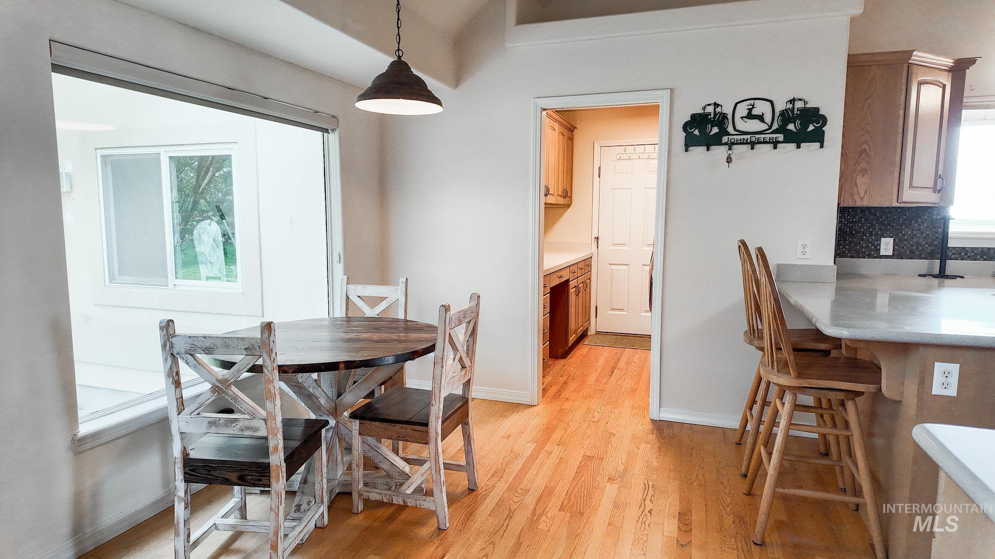Dining area with light wood finished floors and healthy amount of natural light