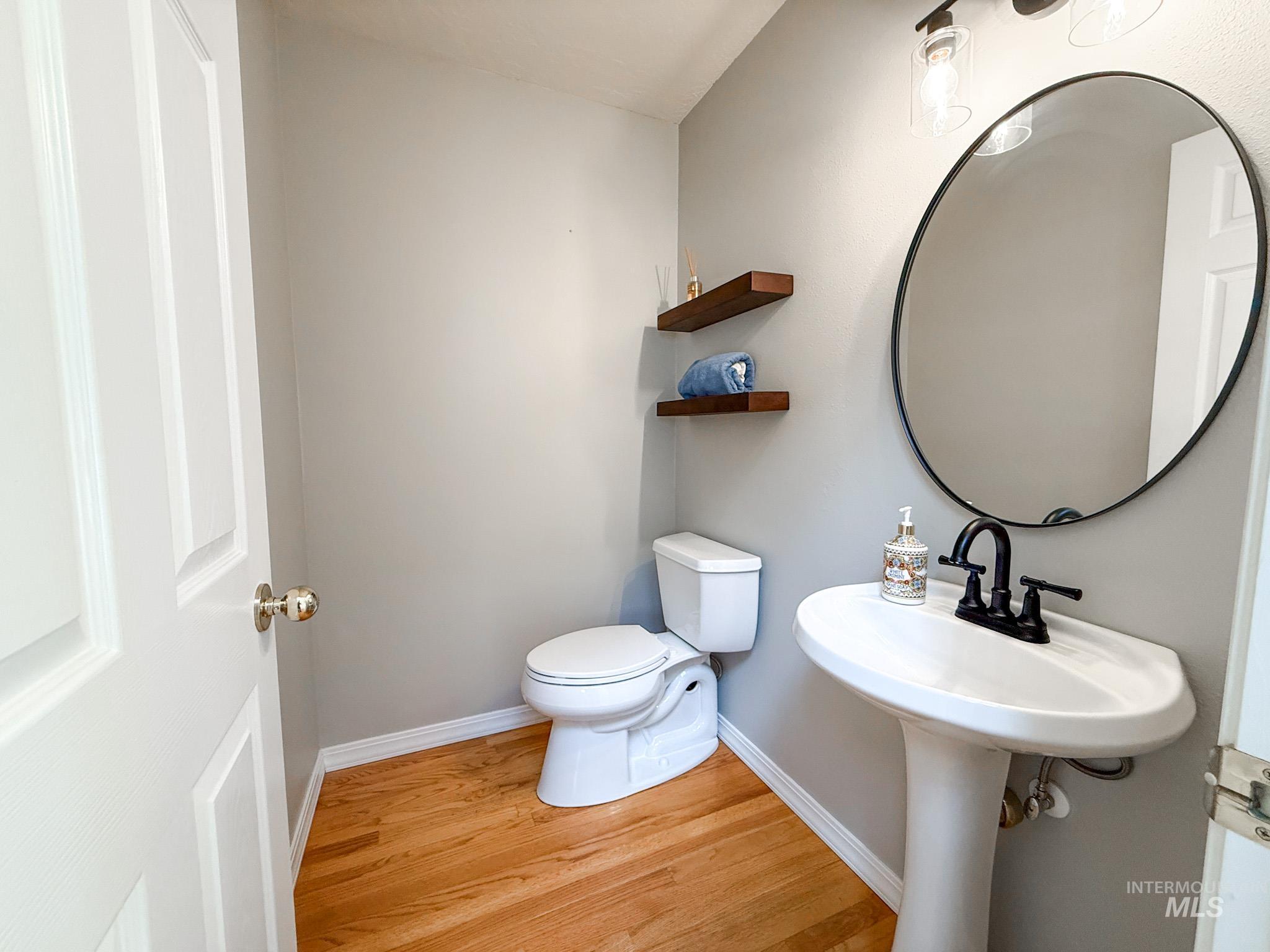 Bathroom with baseboards and light wood-style floors