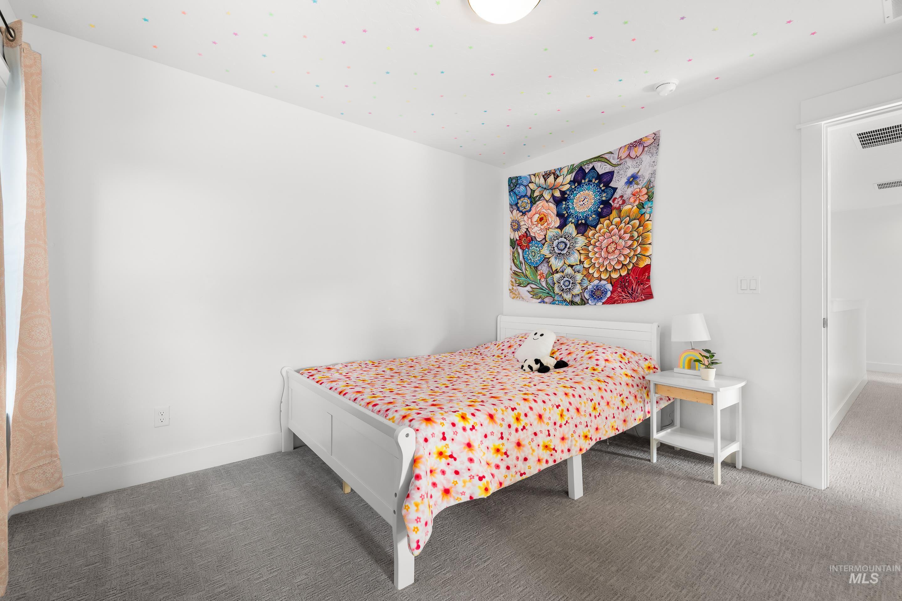 Bedroom featuring carpet and baseboards