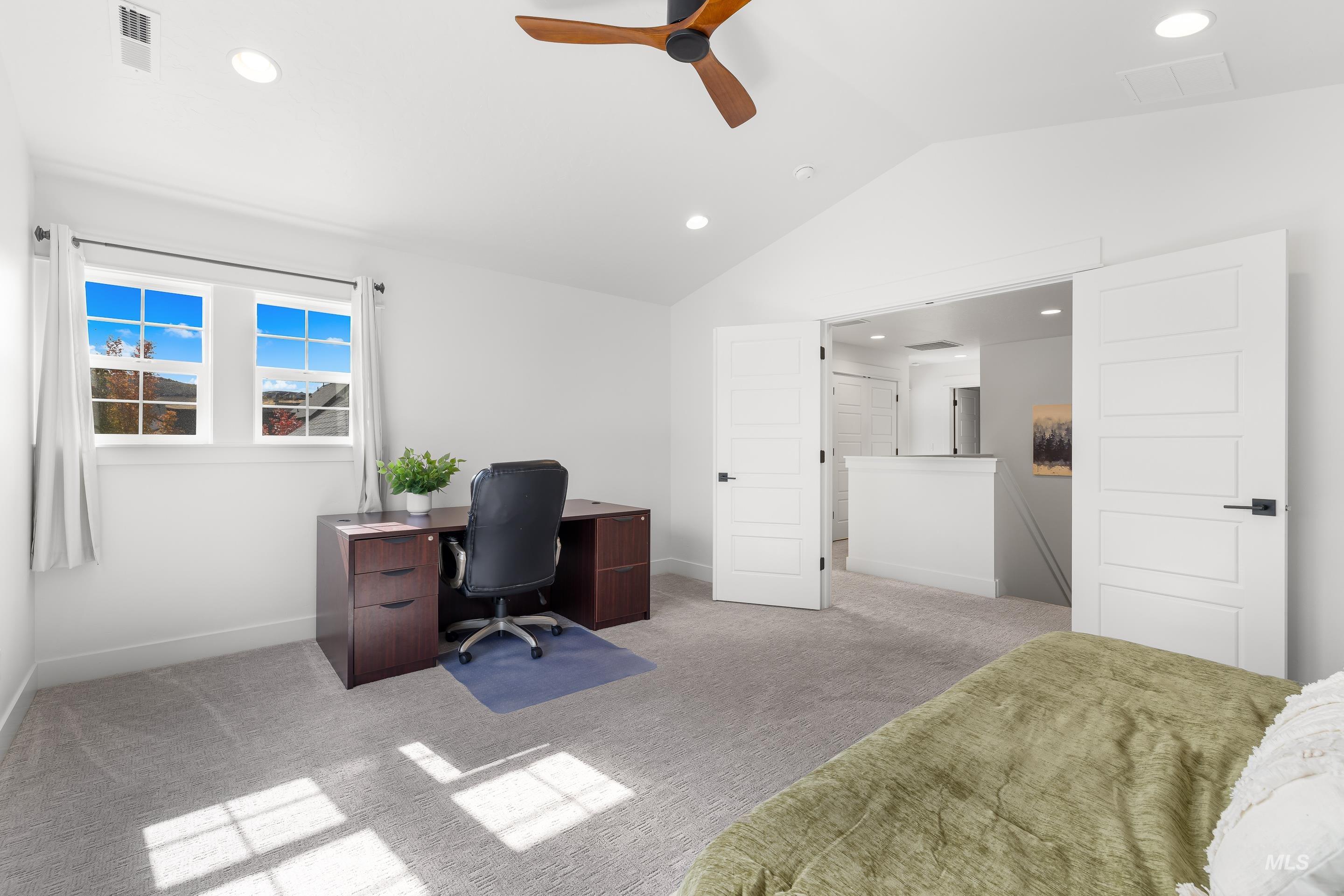 Office space featuring light carpet, recessed lighting, vaulted ceiling, and ceiling fan