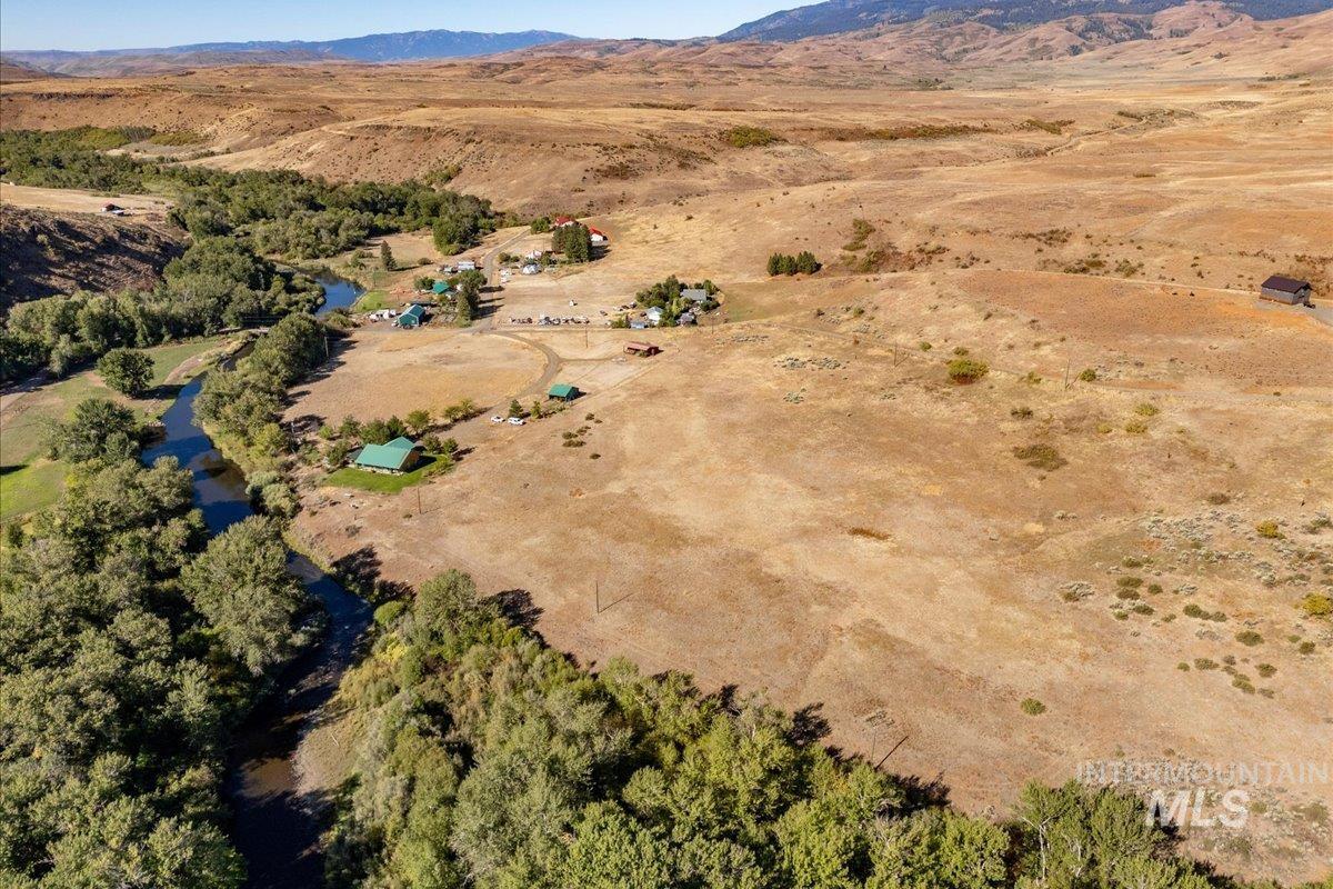Aerial view of property's location with rural landscape and a mountain backdrop