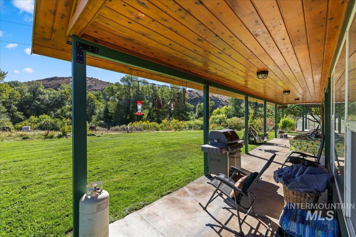 View of patio / terrace with area for grilling and a mountain view