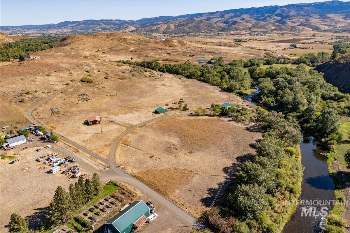Aerial view of property and surrounding area with rural landscape and mountains