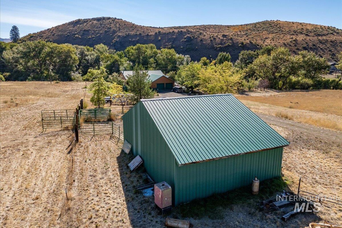 View of pole building with a mountain view and a rural view