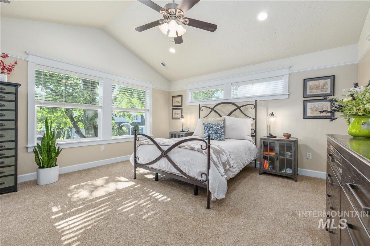 Bedroom featuring light carpet, vaulted ceiling, recessed lighting, and a ceiling fan