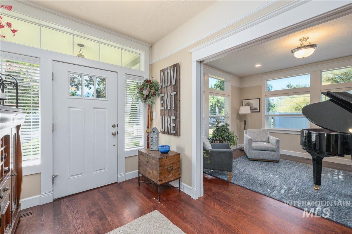Entryway featuring dark wood finished floors and baseboards