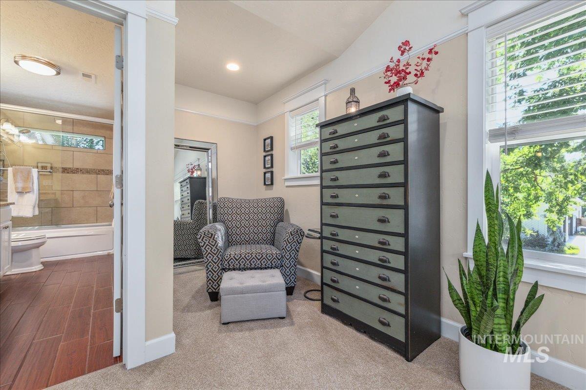 Living area with baseboards and carpet