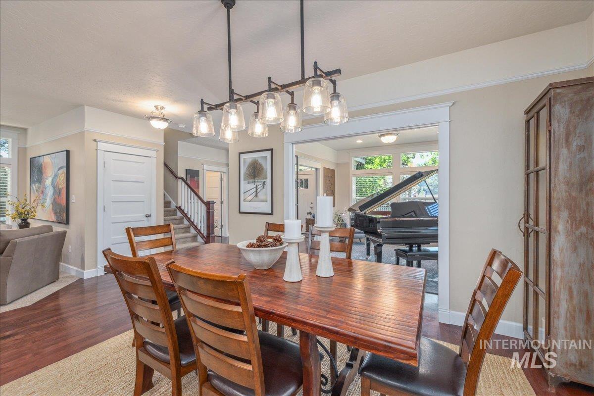 Dining area featuring stairway, dark wood finished floors, and a textured ceiling