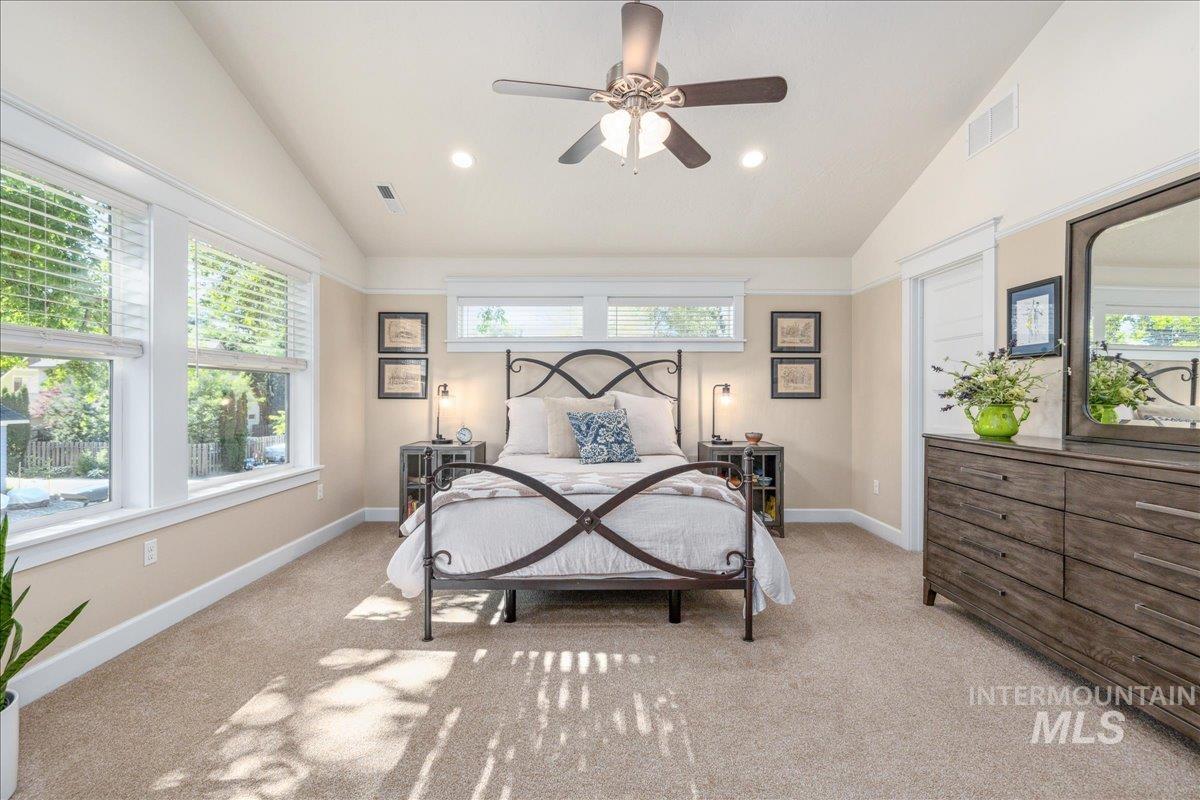 Bedroom with light carpet, lofted ceiling, a ceiling fan, and recessed lighting