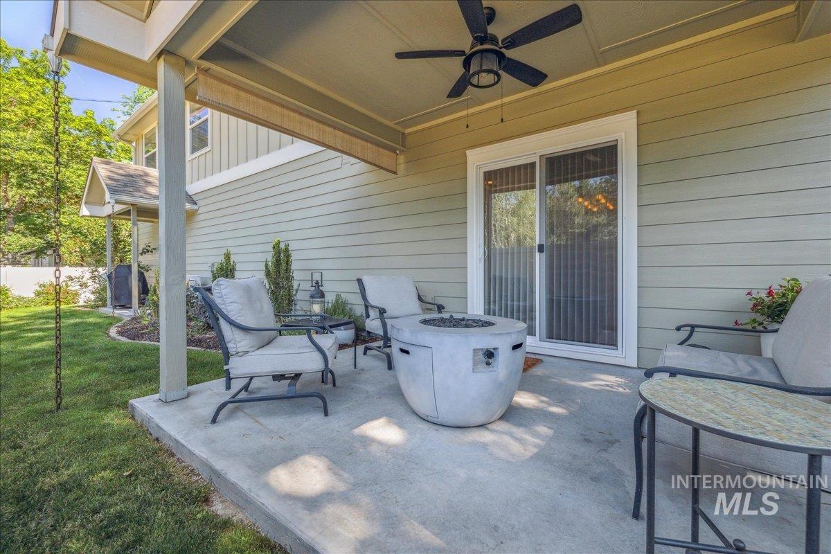 View of patio / terrace featuring an outdoor fire pit and a ceiling fan