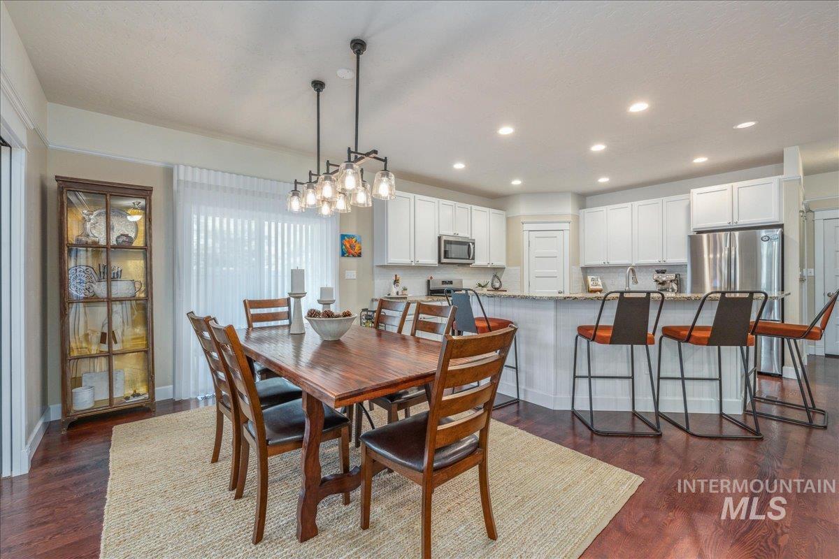 Dining space with recessed lighting and dark wood-style floors