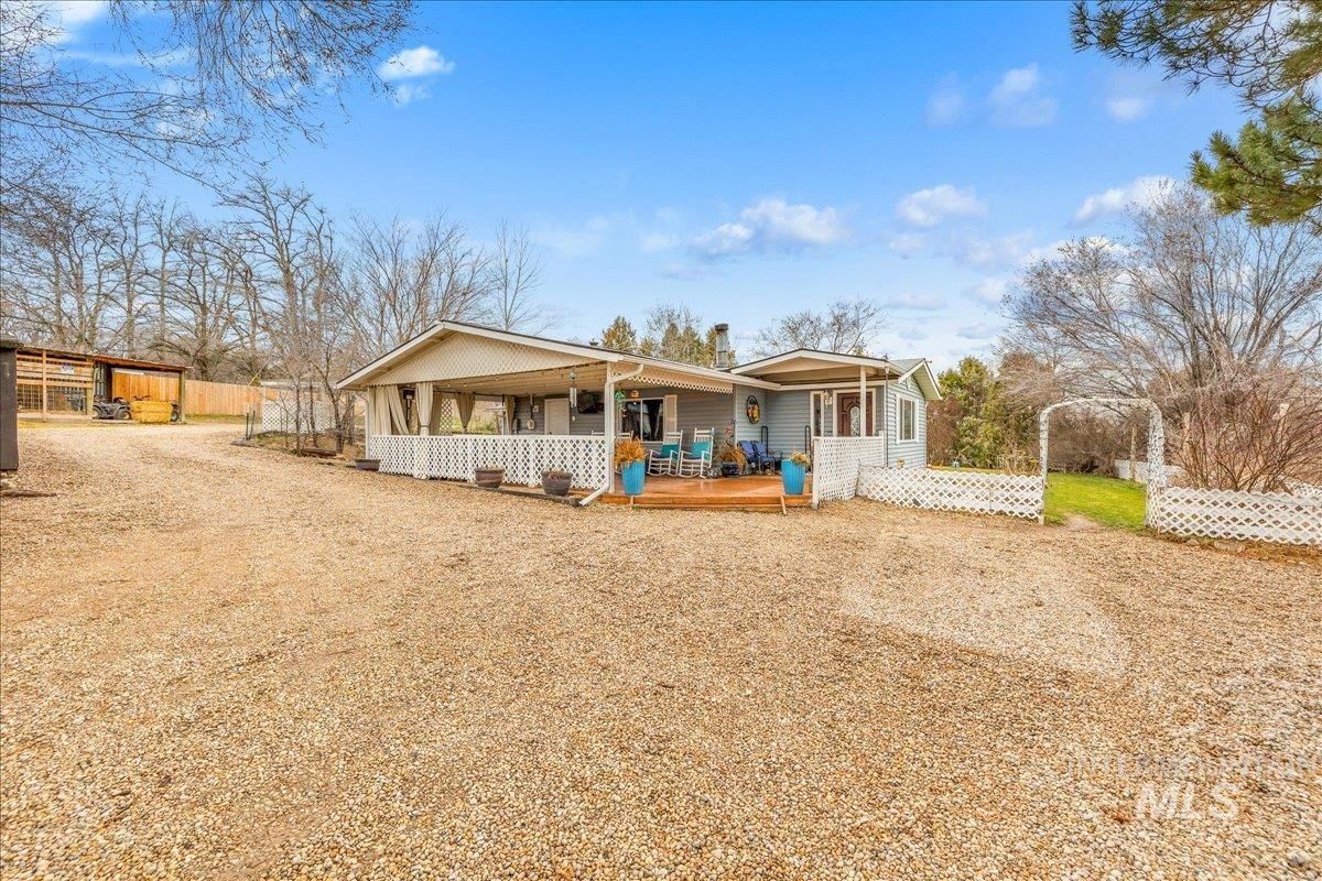 View of front of house featuring a wooden deck
