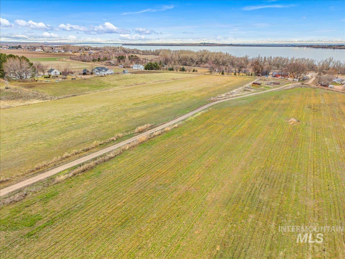 View of rural area featuring a large body of water and rows of crops