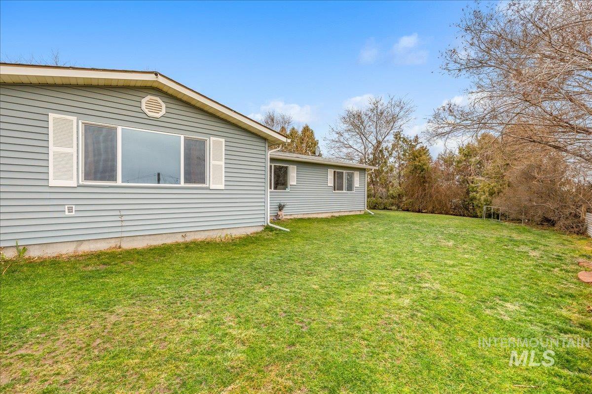 Rear view of house with a lawn
