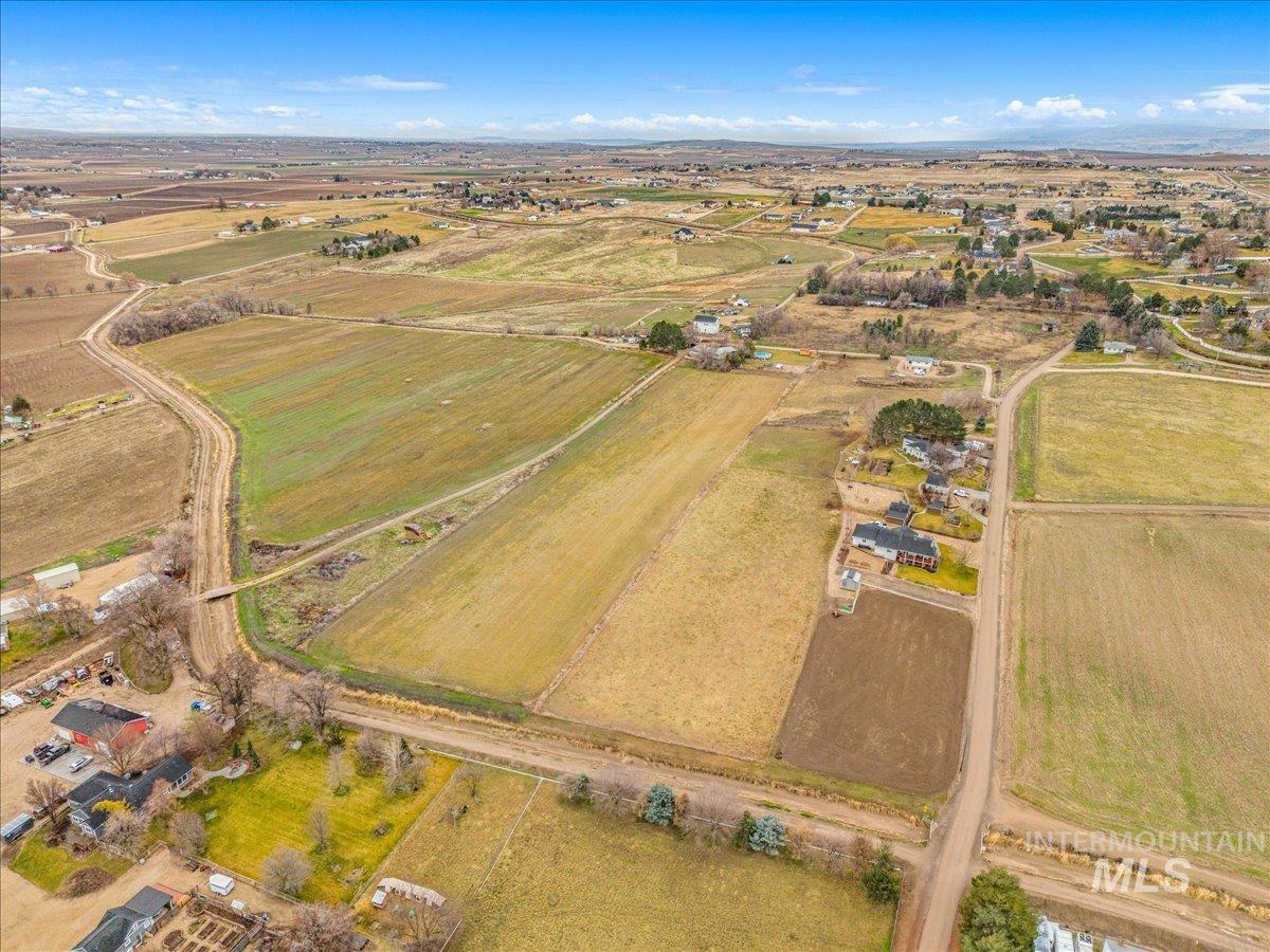 Aerial overview of property's location with rural landscape and extensive farmland