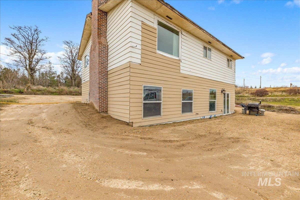 View of side of property featuring a chimney