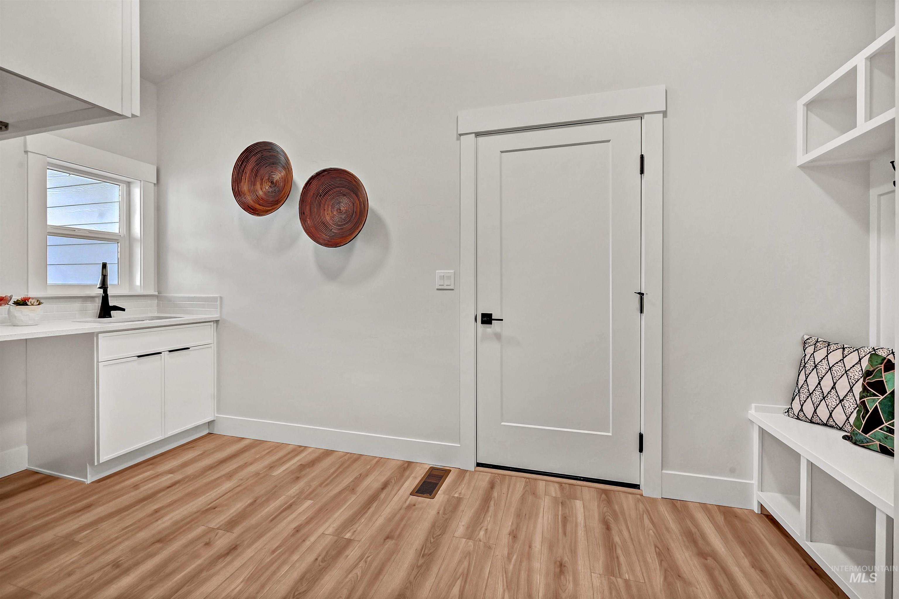 Mudroom featuring light wood-type flooring