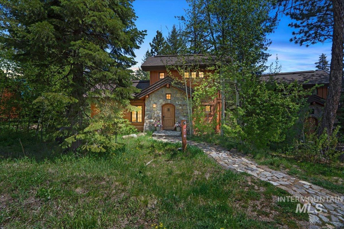 Stone and wood-sided exterior featuring a natural stone pathway