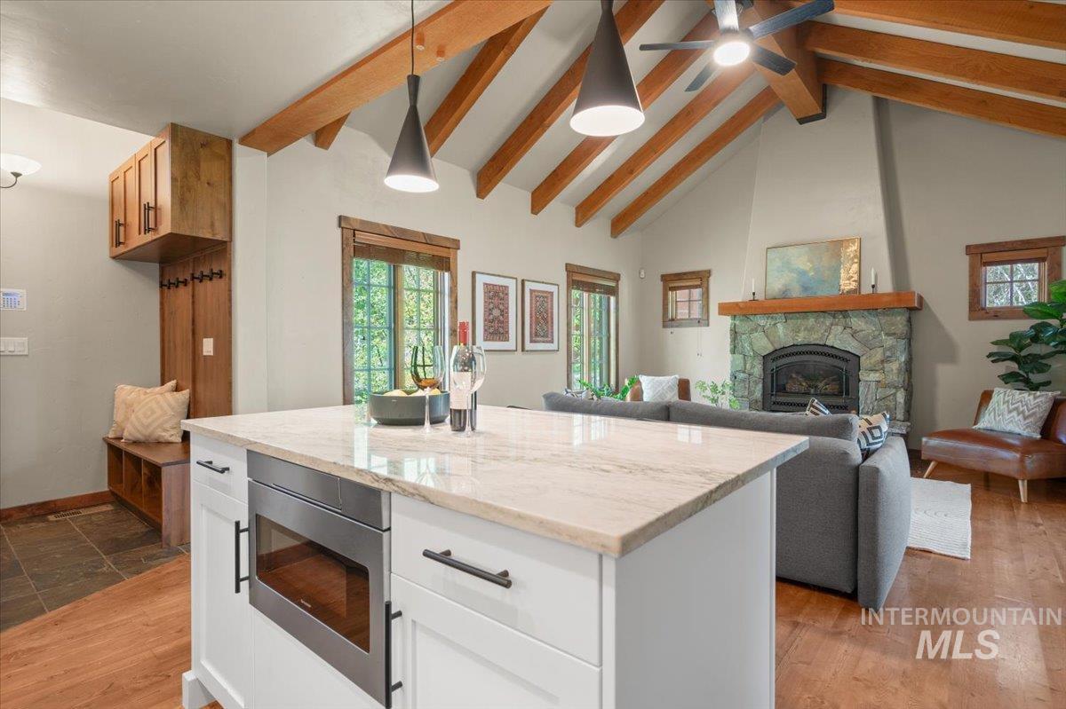 Kitchen island featuring a light-toned countertop and built-in microwave